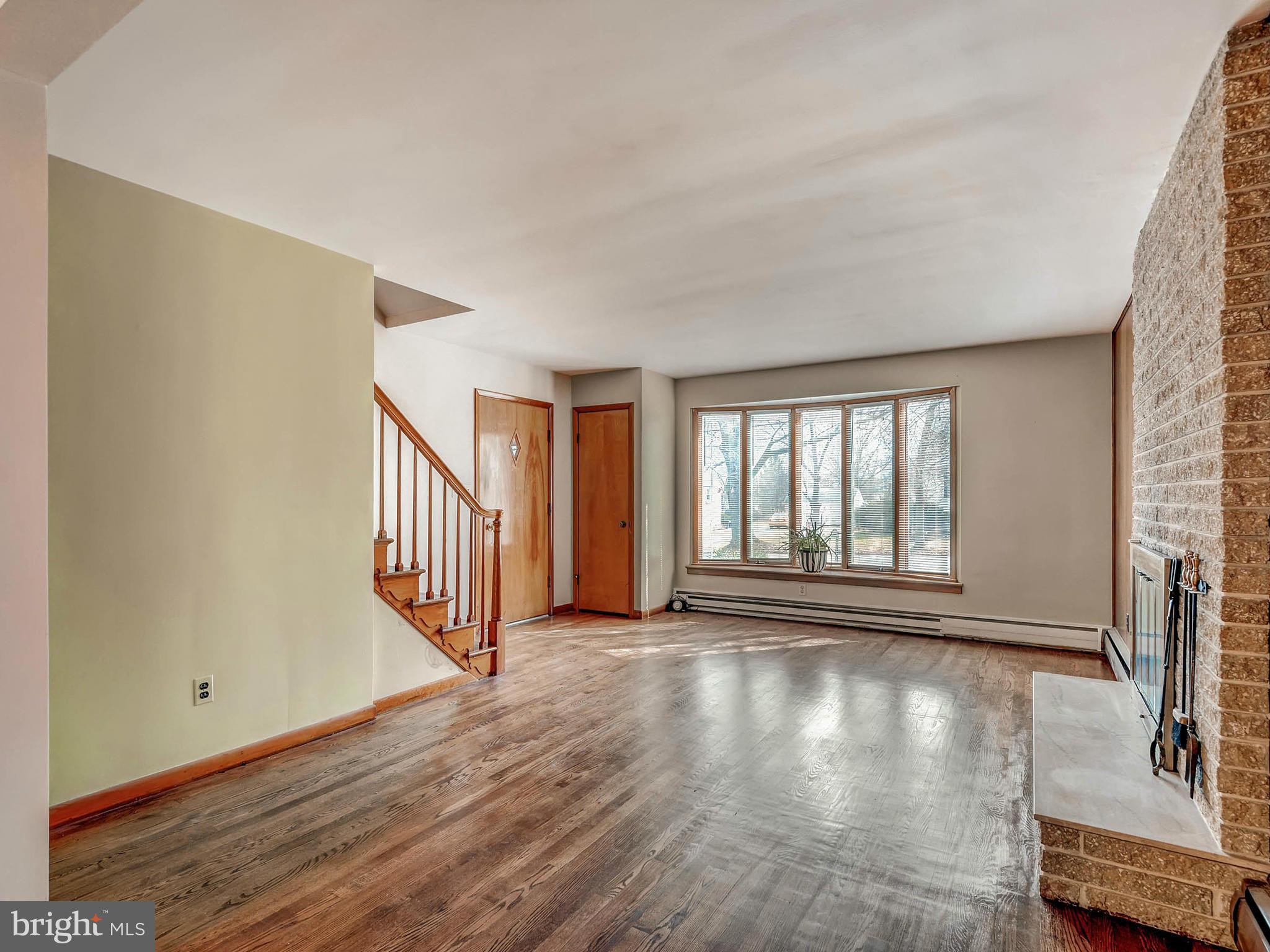 7306 Manchester Road Baltimore, MD 21222 - Photo 8 of 24 a view of an empty room with wooden floor and a window
