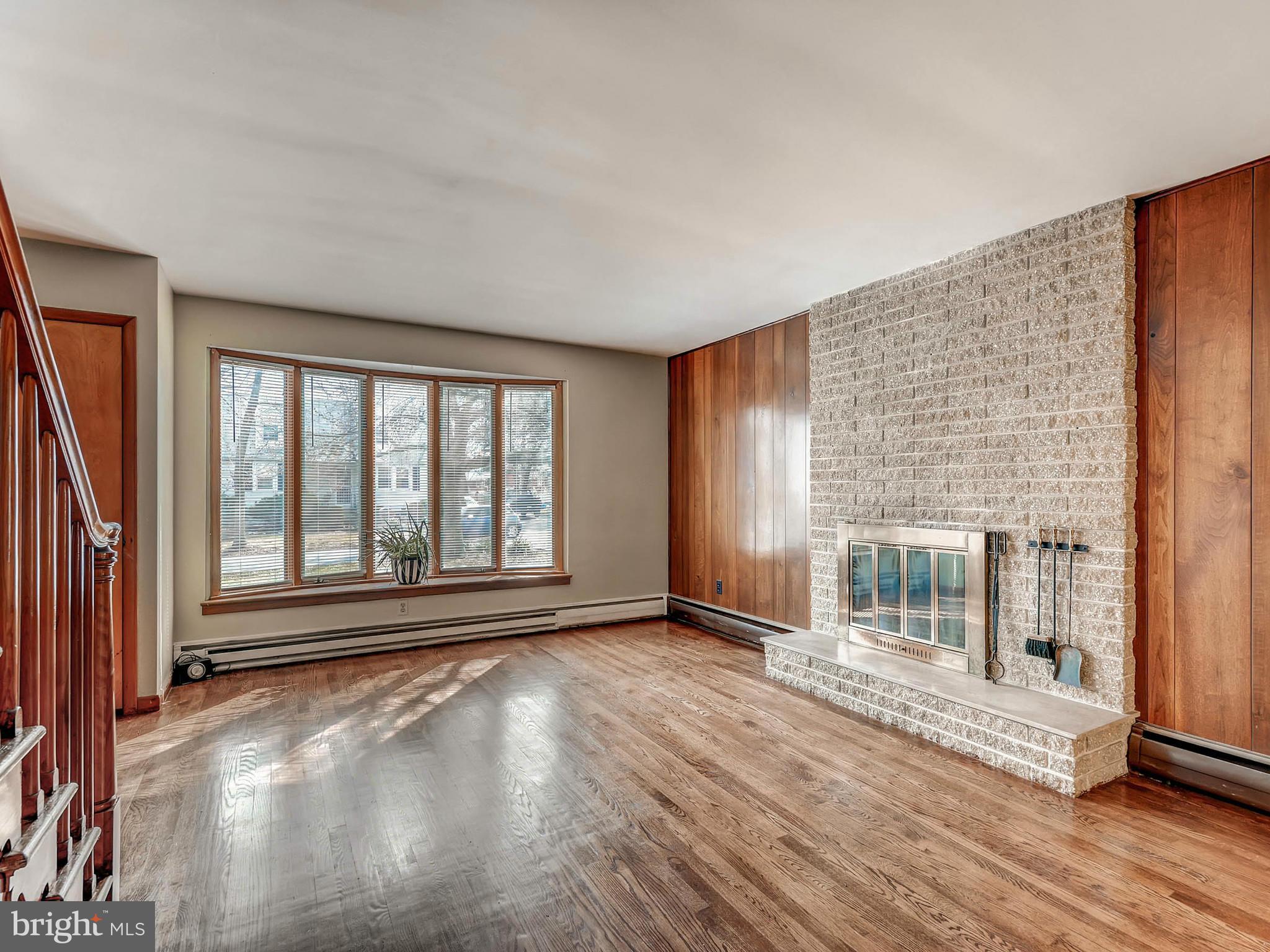 7306 Manchester Road Baltimore, MD 21222 - Photo 9 of 24 a view of an empty room with wooden floor and a window