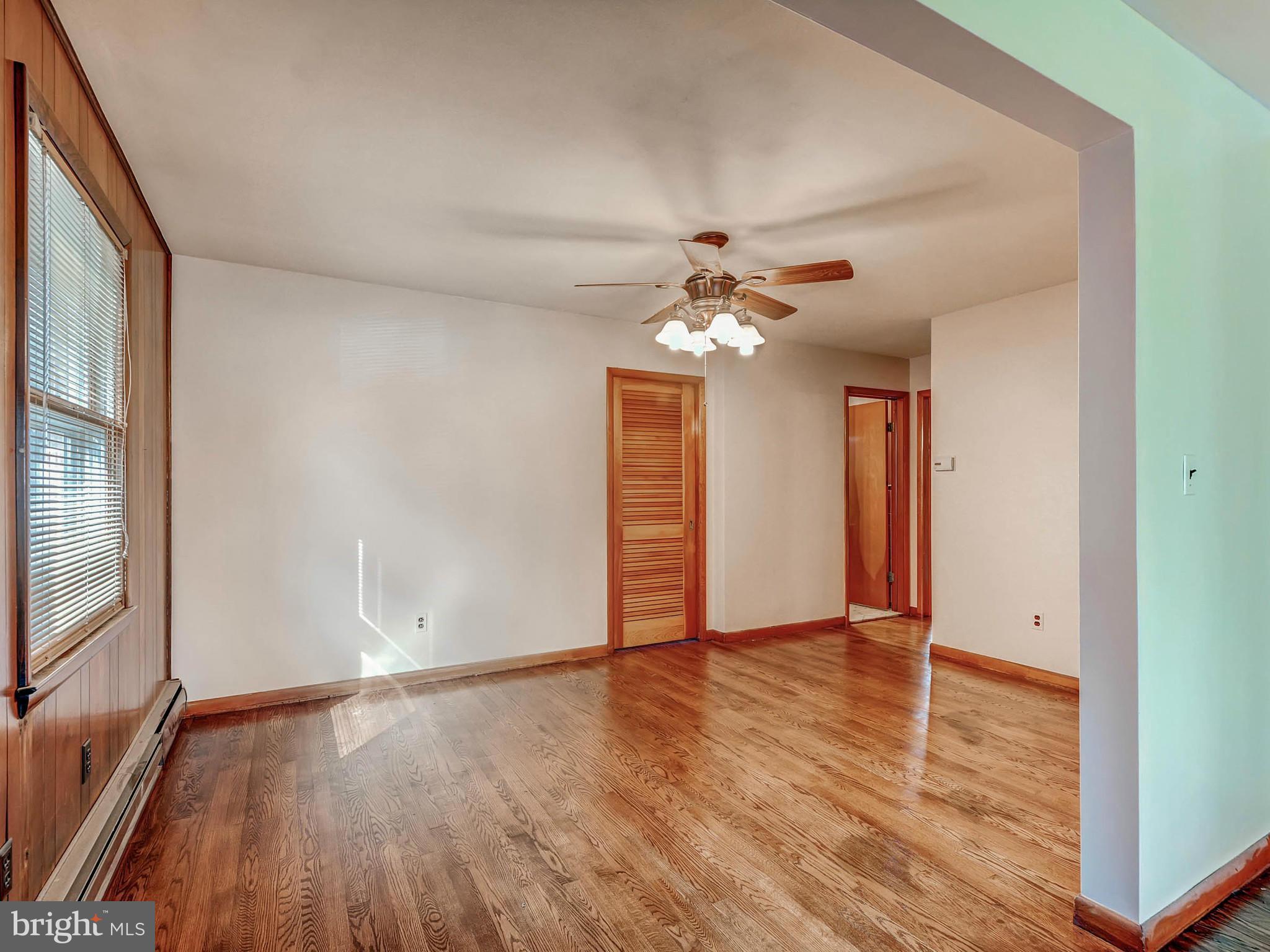 7306 Manchester Road Baltimore, MD 21222 - Photo 10 of 24 a view of an empty room with wooden floor and chandelier