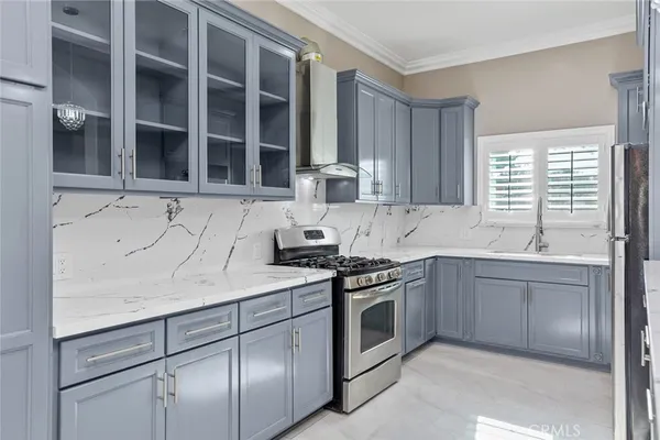 a kitchen with cabinets stainless steel appliances and window