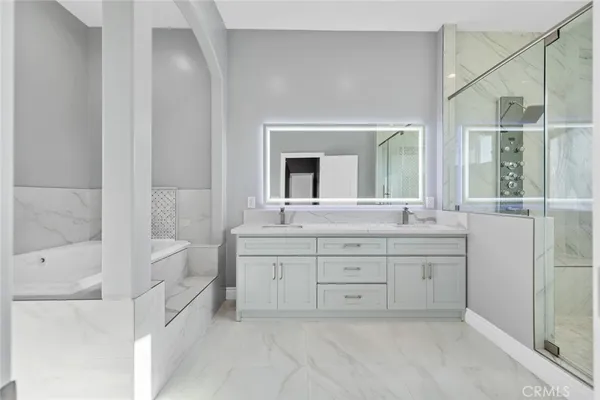 a bathroom with a shower sink and mirror
