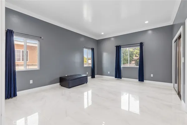 a view of an empty room with window and cabinet