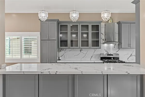 a kitchen with a sink and chandelier