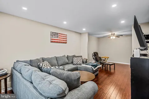 a living room with furniture and wooden floor