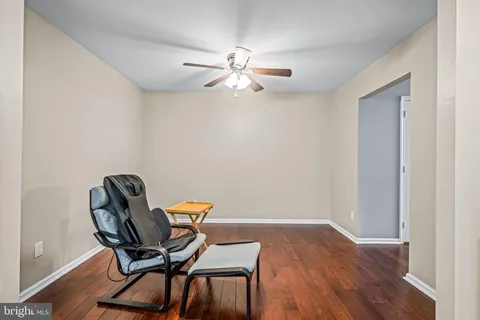 a view of a workspace with furniture and wooden floor
