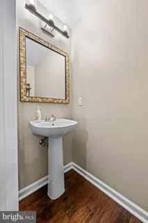 a bathroom with a sink toilet and mirror