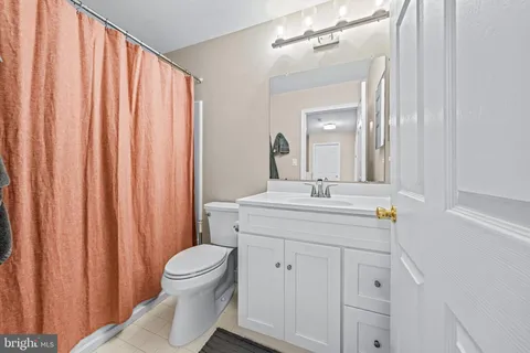 a bathroom with a toilet a sink and a mirror