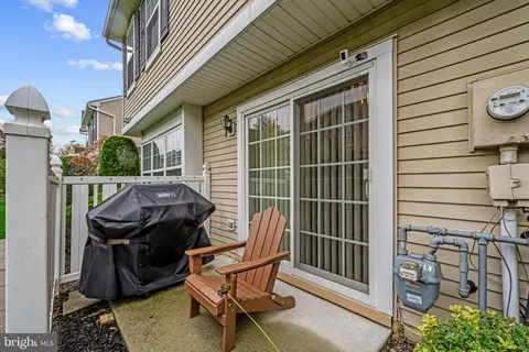a view of a patio with table and chairs and wooden floor