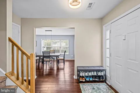 a dining room with furniture wooden floor and a rug