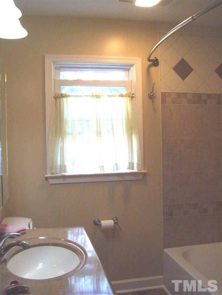410 Jones Franklin Road Raleigh, NC 27606 - Photo 12 of 17 a bathroom with a sink a toilet and a window