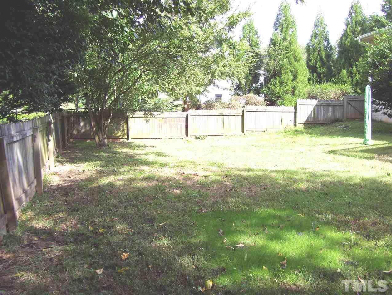 410 Jones Franklin Road Raleigh, NC 27606 - Photo 17 of 17 a view of yard with tree and wooden fence