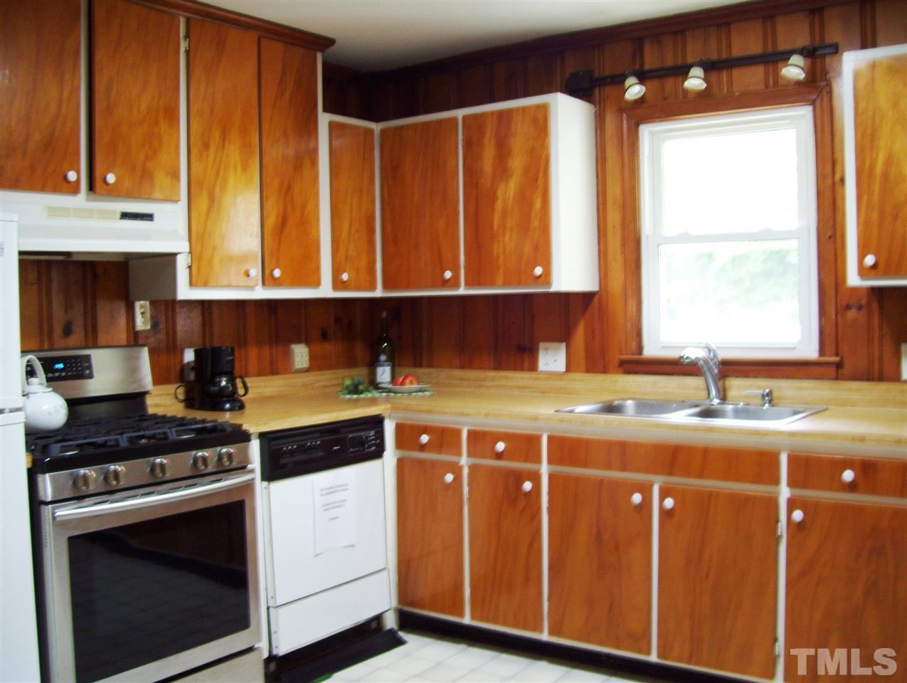 410 Jones Franklin Road Raleigh, NC 27606 - Photo 6 of 17 a kitchen with a stove a sink and a microwave