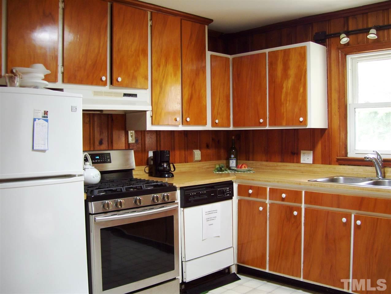410 Jones Franklin Road Raleigh, NC 27606 - Photo 7 of 17 a kitchen with stainless steel appliances granite countertop a stove a sink and a microwave