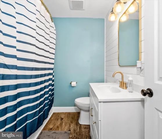 a bathroom with a sink toilet and mirror
