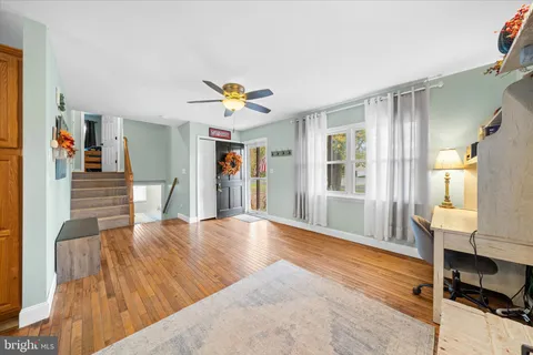 a view of an entryway with wooden floor and a sink