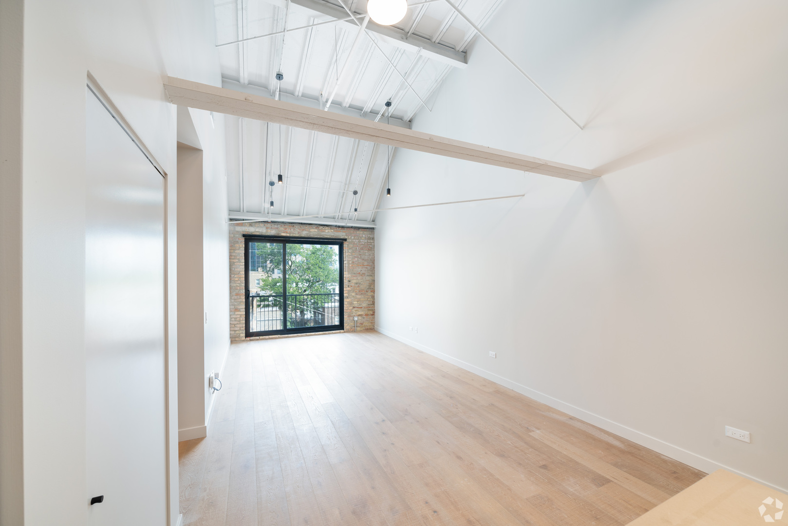1706 Sherman Avenue, Unit 404 Evanston, IL 60201 - Photo 2 of 8 an empty room with wooden floor and windows
