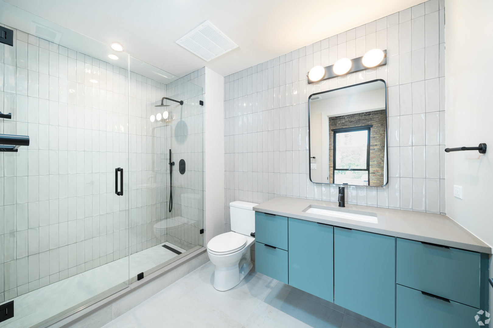 1706 Sherman Avenue, Unit 404 Evanston, IL 60201 - Photo 7 of 8 a bathroom with a double vanity sink toilet mirror and shower