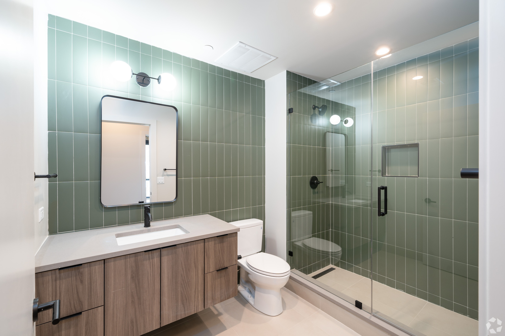 1706 Sherman Avenue, Unit 404 Evanston, IL 60201 - Photo 8 of 8 a bathroom with a double vanity sink toilet and shower