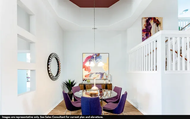 a living room with furniture a rug and white walls