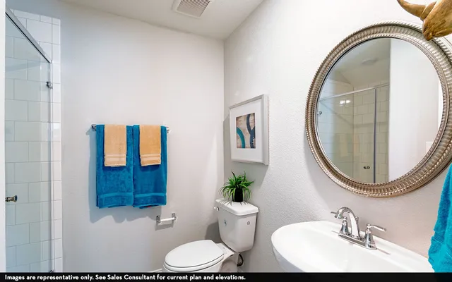 a bathroom with a toilet a sink and a mirror