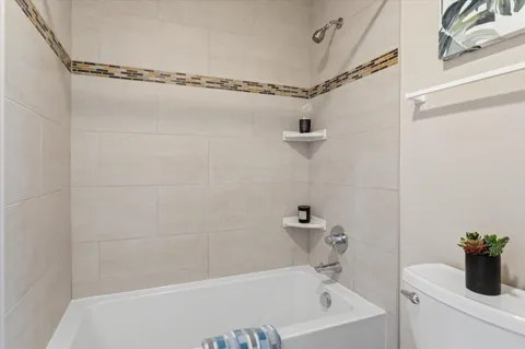 a bath tub sitting next to a white sink and a shower