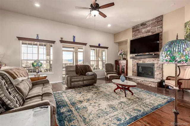 a living room with furniture a flat screen tv and a fireplace