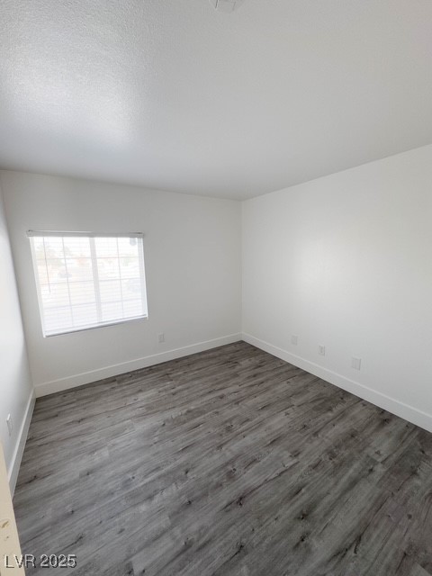 3686 Lincoln Road Las Vegas, NV 89115 - Photo 20 of 26 Empty room with baseboards and dark wood-type flooring