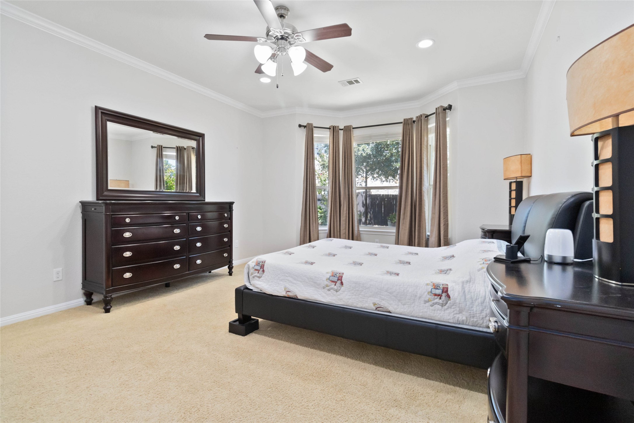 8032 Via Verde Drive Austin, TX 78739 - Photo 18 of 37 a bedroom with a bed a chandelier and a window