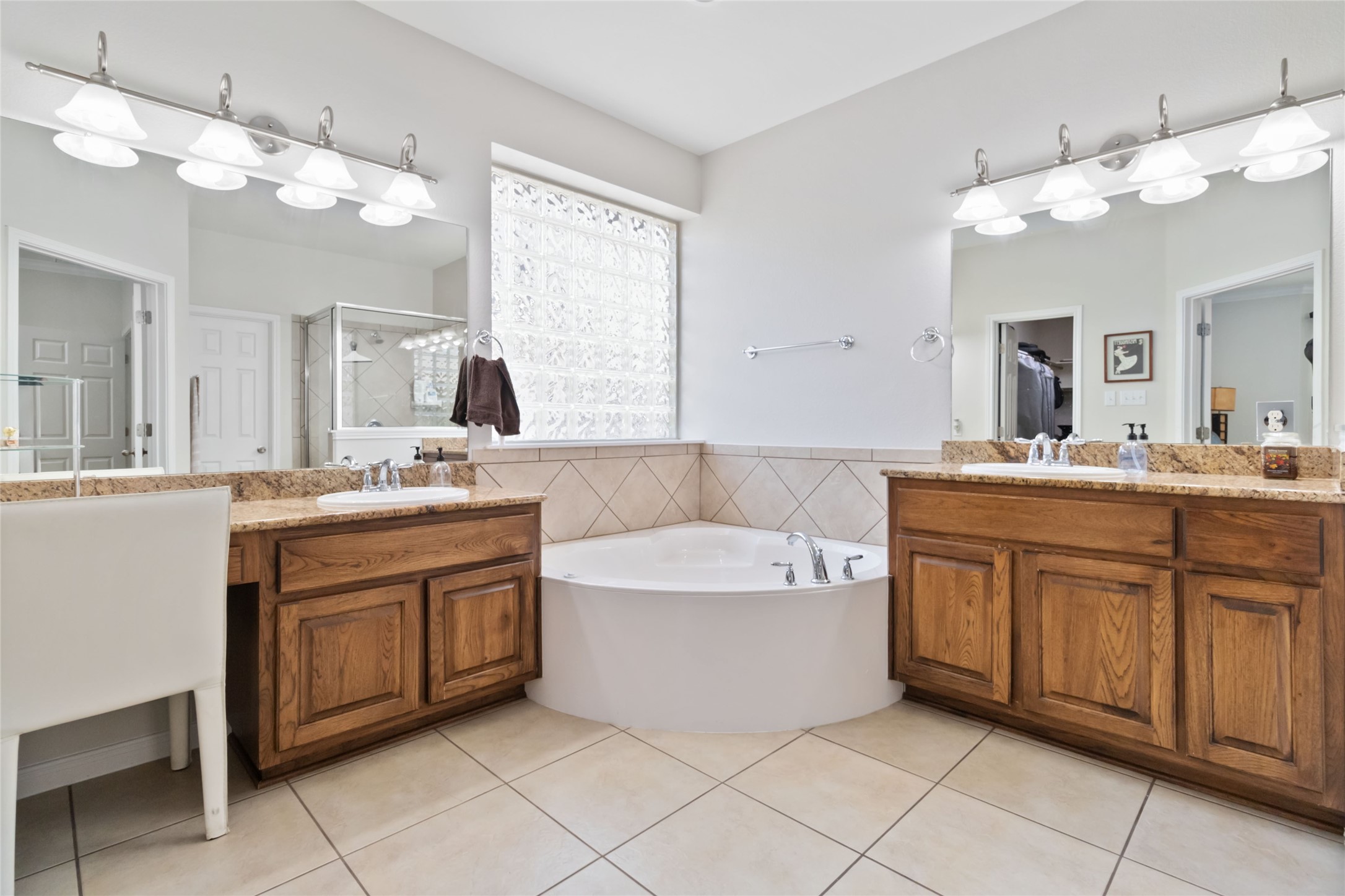 8032 Via Verde Drive Austin, TX 78739 - Photo 19 of 37 a spacious bathroom with a double vanity sink mirror and bathtub