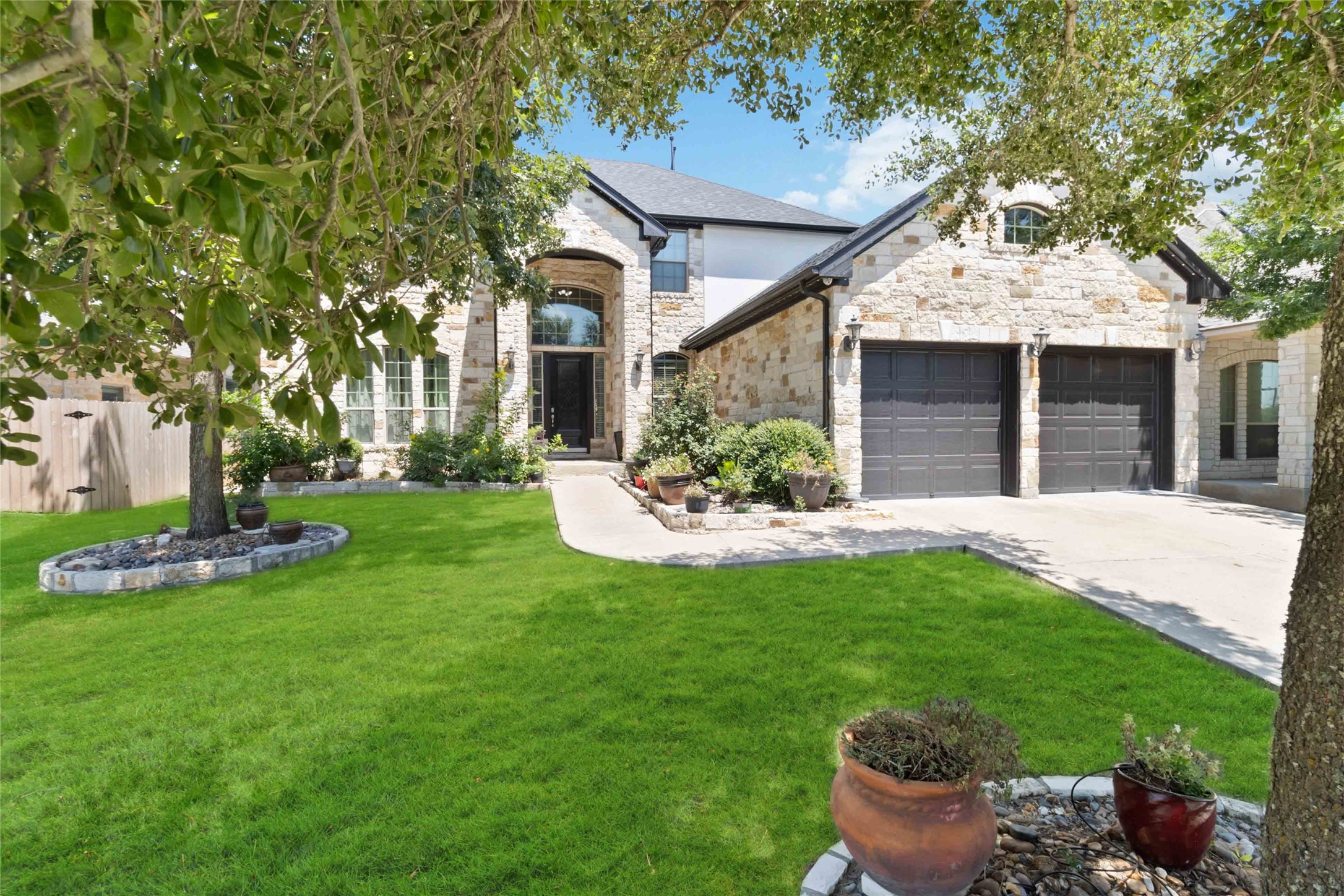 8032 Via Verde Drive Austin, TX 78739 - Photo 2 of 37 a front view of a house with a garden