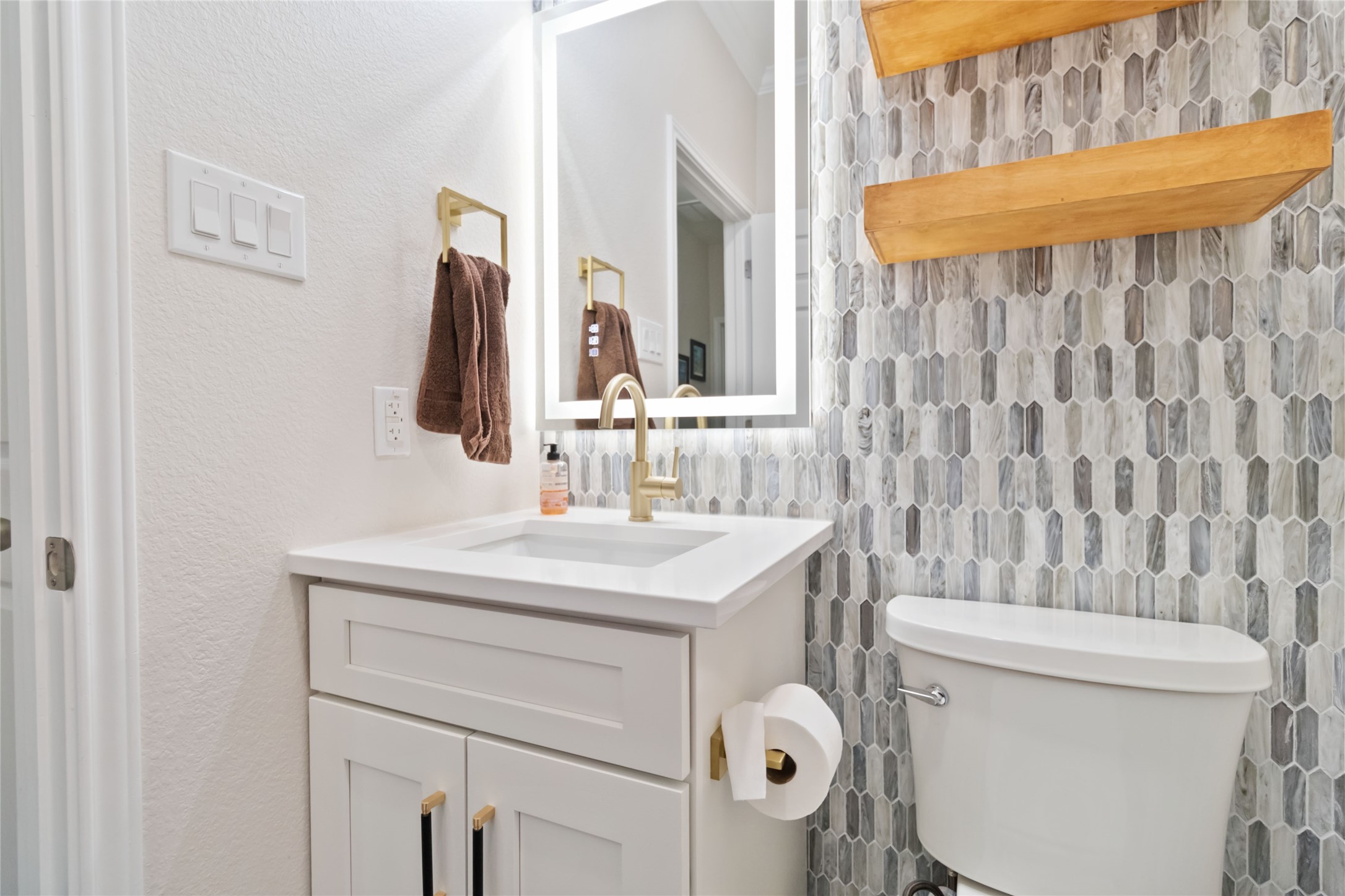 8032 Via Verde Drive Austin, TX 78739 - Photo 21 of 37 a bathroom with a sink a toilet and shower curtain