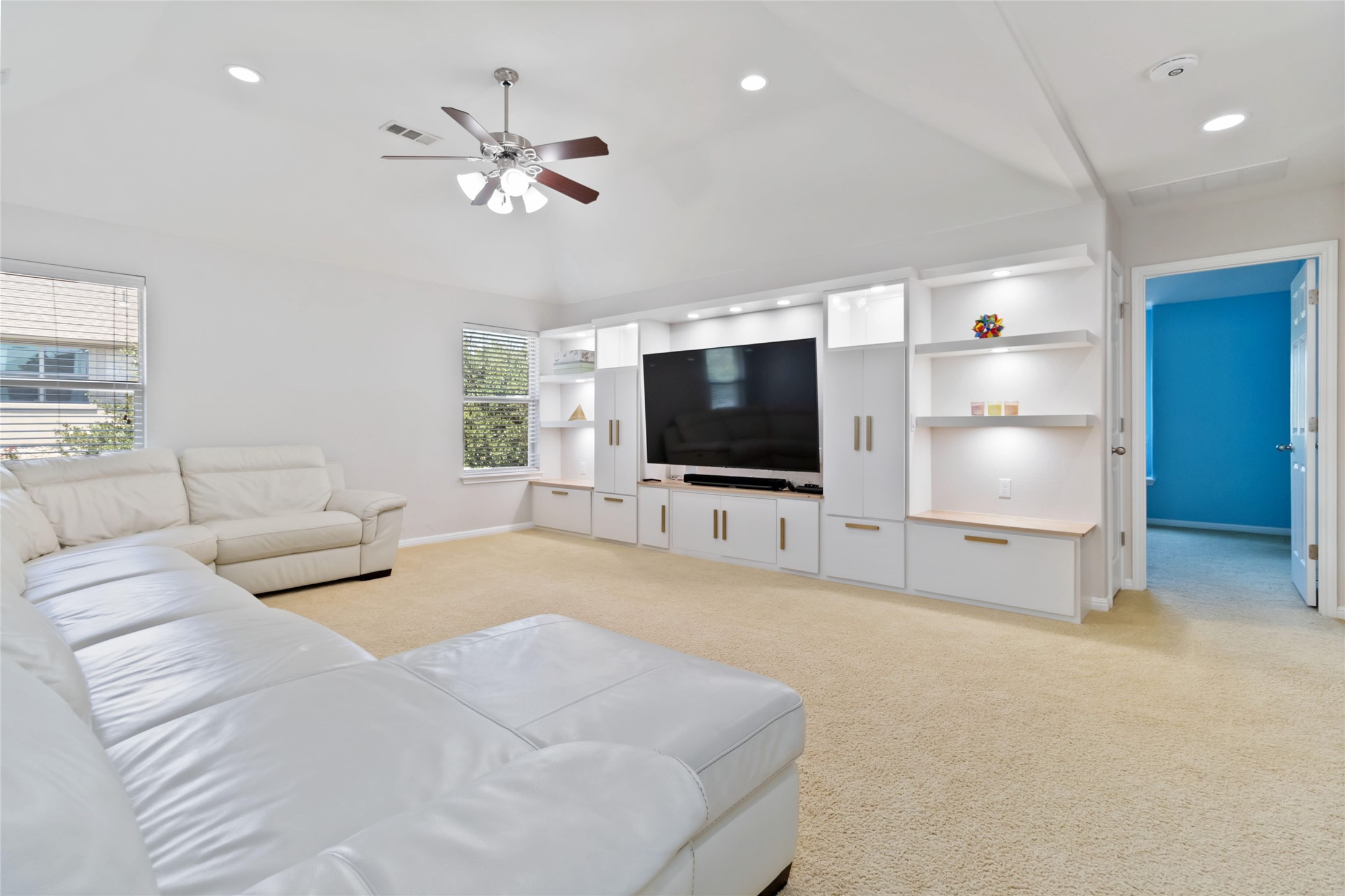 8032 Via Verde Drive Austin, TX 78739 - Photo 24 of 37 a living room with furniture and a flat screen tv