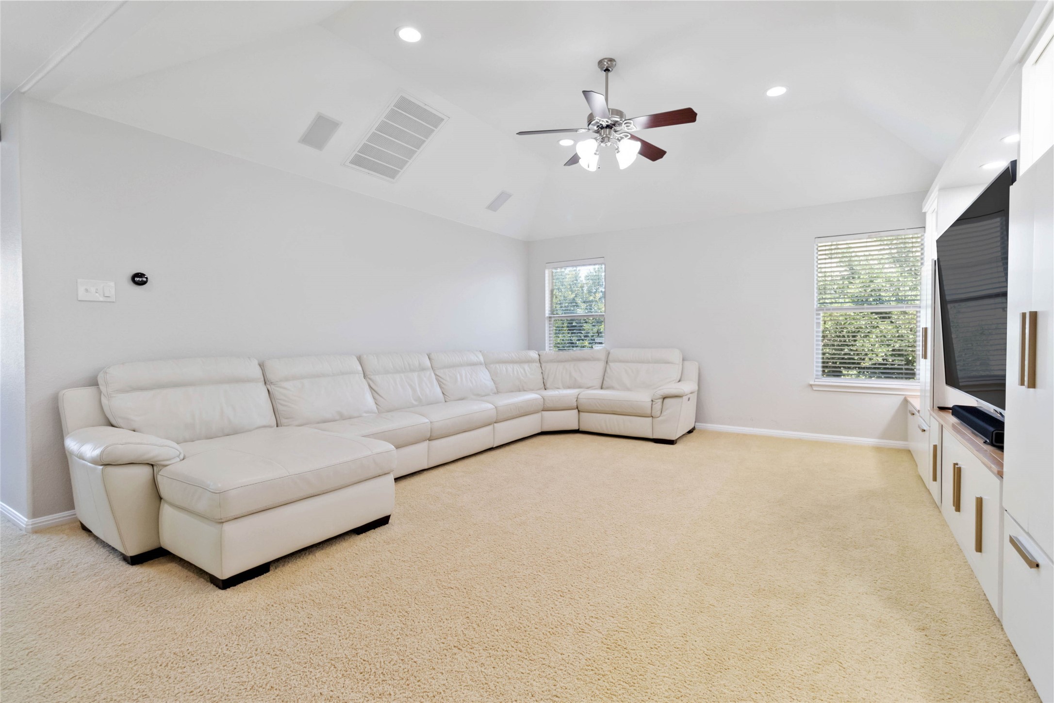 8032 Via Verde Drive Austin, TX 78739 - Photo 25 of 37 a living room with furniture and a flat screen tv