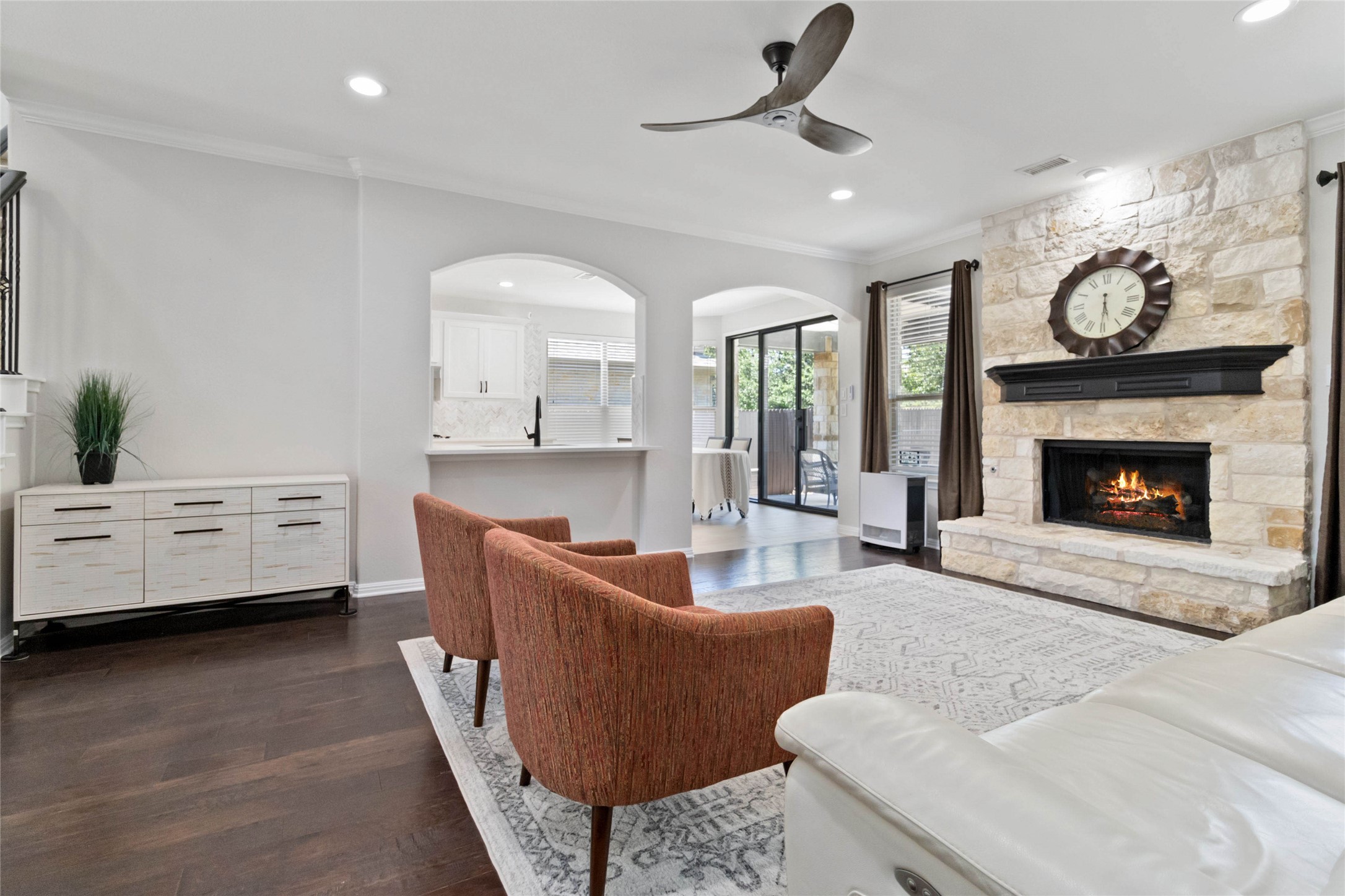 8032 Via Verde Drive Austin, TX 78739 - Photo 8 of 37 a living room with furniture and a fireplace