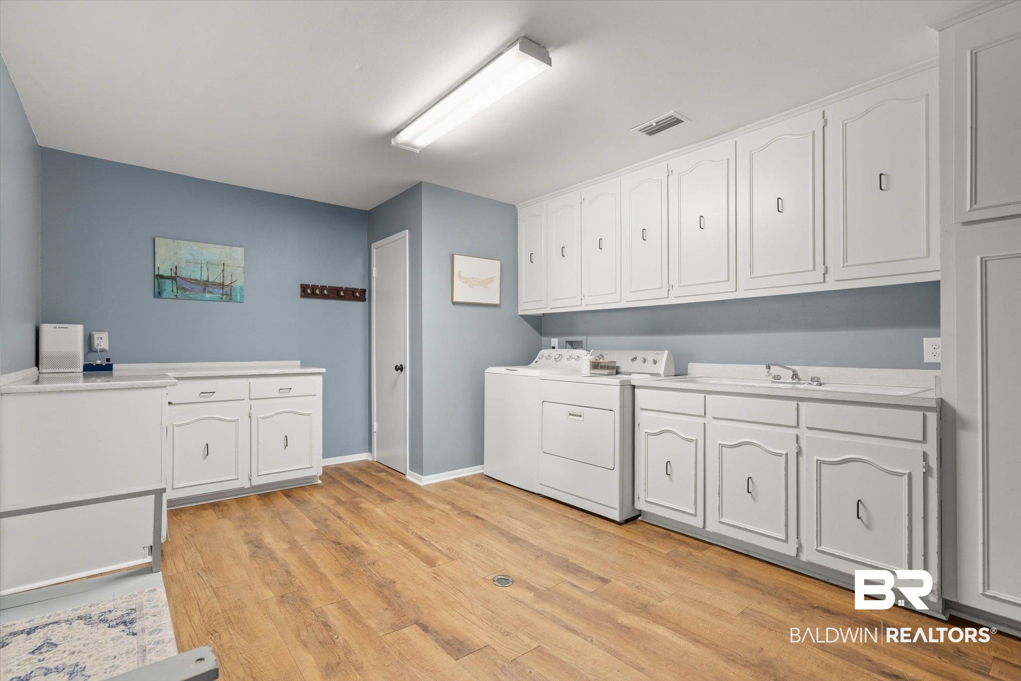 254 Woodlands Avenue Mobile, AL 36607 - Photo 16 of 50 Washroom with light wood-style floors, cabinet space, and separate washer and dryer