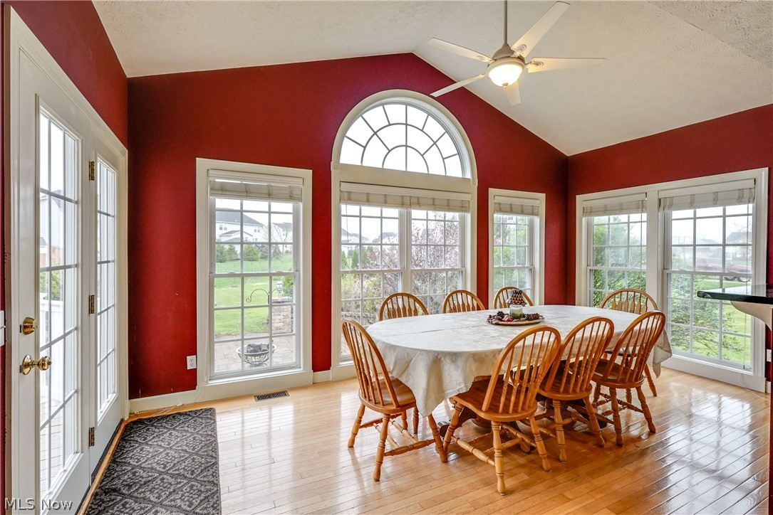4561 Ridgestone Way Medina, OH 44256 - Photo 17 of 50 Morning / Informal Dining Room with high vaulted ceiling, ceiling fan, light hardwood flooring, loads of light, easy access to the patio.