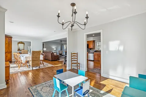 a dining room with furniture a rug and wooden floor