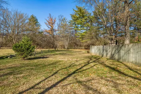 a view of a house with a yard covered in snow