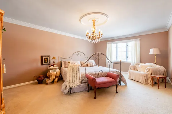 a bed room with furniture and a chandelier