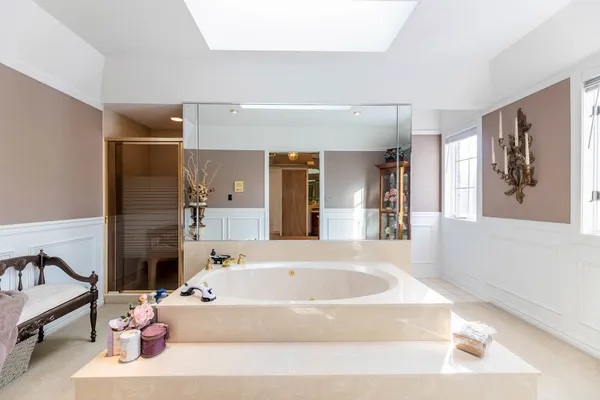 a spacious bathroom with a tub shower and sink