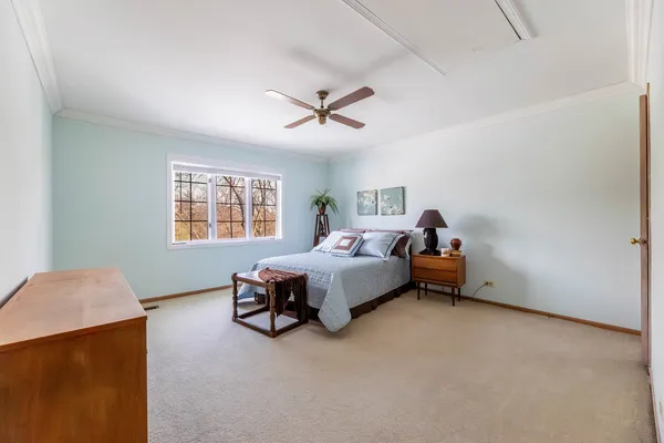 a bed room with a bed and a chair