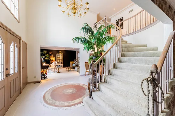 an entryway with a flower pot and a bookshelf