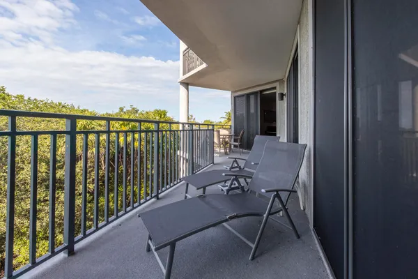 a view of a balcony with chairs