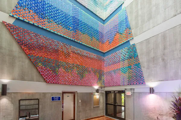 a view of a hallway with a livingroom and a bathroom with sink