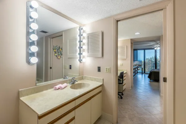 a bathroom with a tub shower and sink