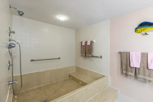 a bathroom with a tub and a shower
