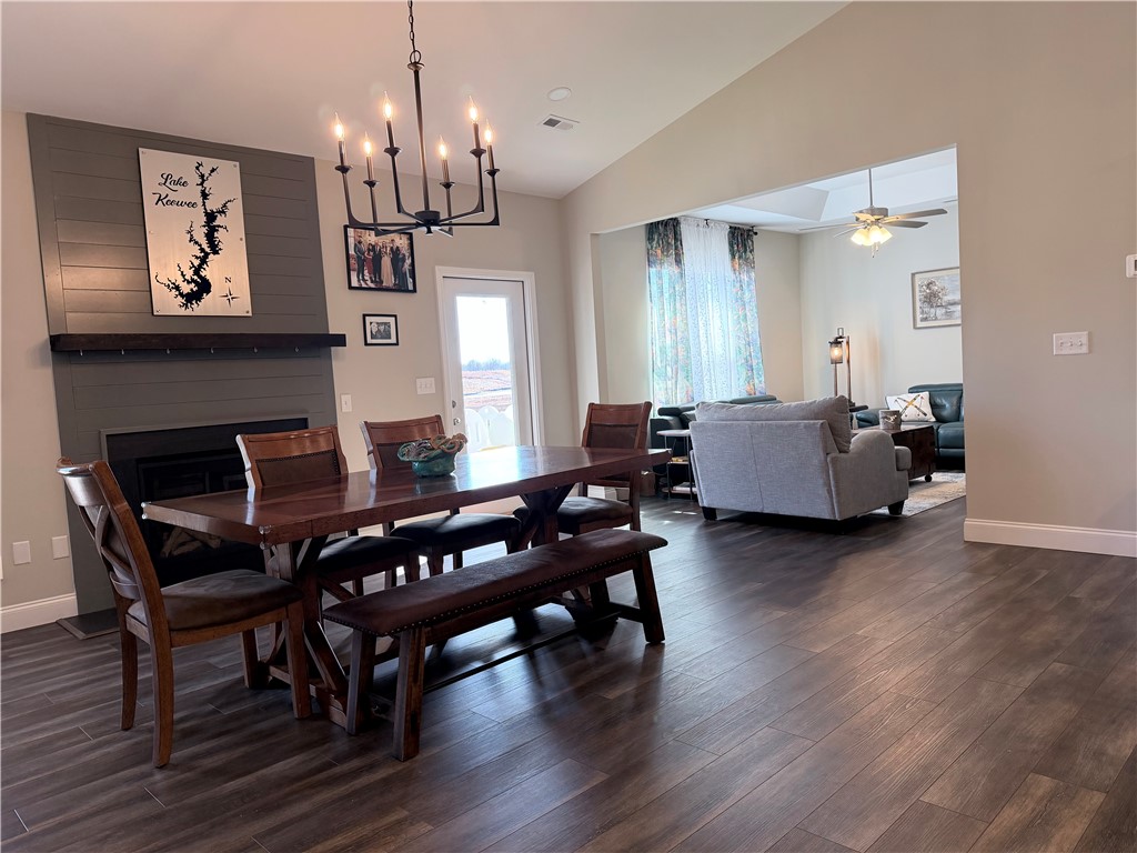 203 Legacy Lane Liberty, SC 29657 - Photo 11 of 47 This inviting dining area seamlessly connects to the living space, featuring elegant flooring and a cozy fireplace.