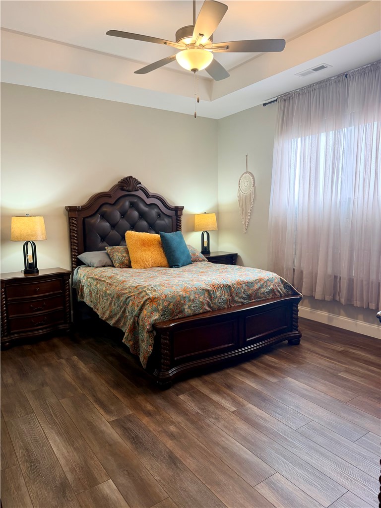 203 Legacy Lane Liberty, SC 29657 - Photo 16 of 47 This inviting main floor primary bedroom features LVP flooring and a classic ceiling fan, creating a comfortable and stylish retreat.