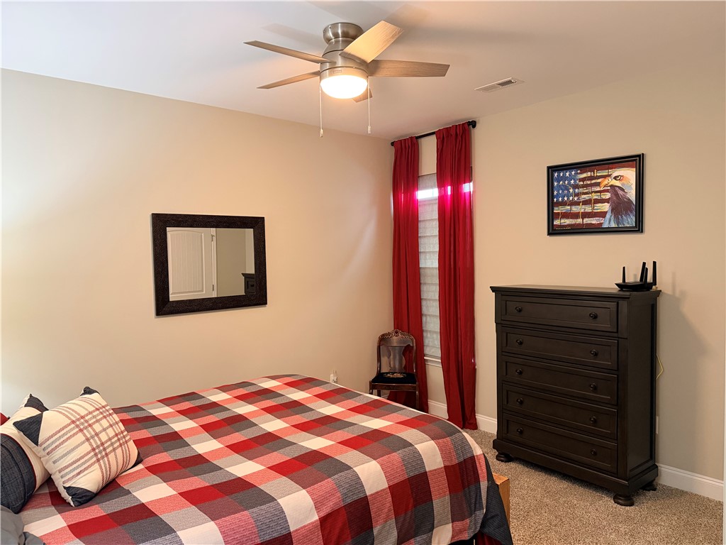 203 Legacy Lane Liberty, SC 29657 - Photo 23 of 47 This cozy bedroom features a ceiling fan, plush carpet, and a window for natural light.