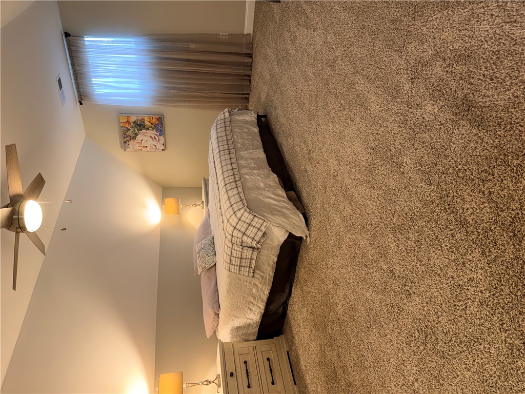 203 Legacy Lane Liberty, SC 29657 - Photo 32 of 47 This spacious bedroom features comfortable carpeting and a ceiling fan for optimal comfort.